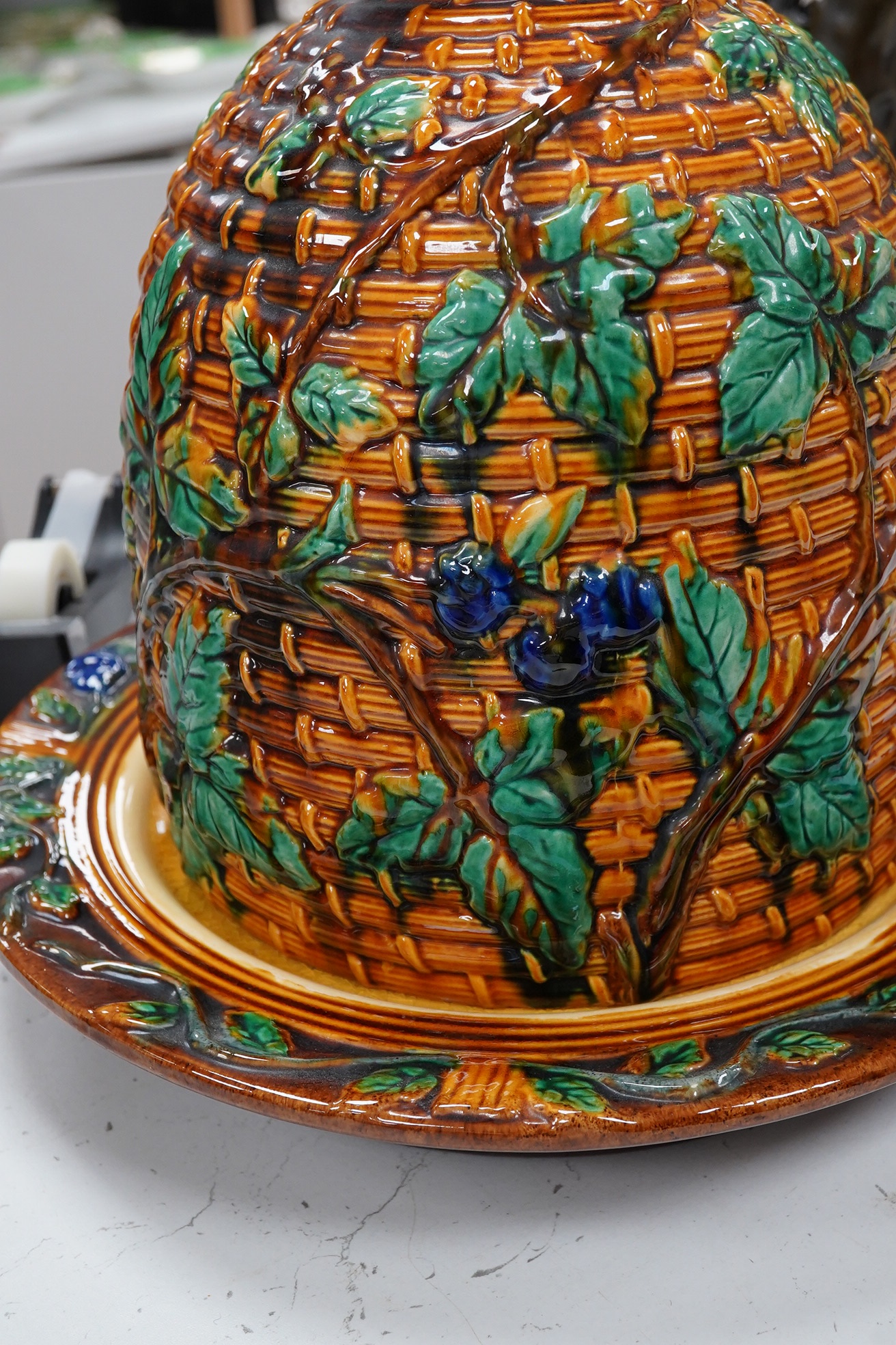 A Minton style majolica cheese dome and stand, 32cm. Condition - fair to good, some crazing